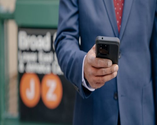 Close up view of hands using a smartphone on public transit